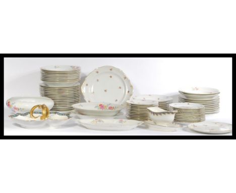 A large group of French Limoges ceramic dinner plates side plates and tureens in floral patterns. Mostly stamped Limoges to v
