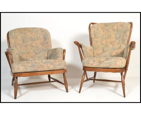 A pair of vintage retro 20th century Ercol beech and elm spindle back Windsor his and her armchairs with paisley seat pads an