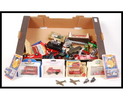 An assorted collection of loose and boxed diecast scale model vehicles by Matchbox , Corgi and Lledo to include with a large 