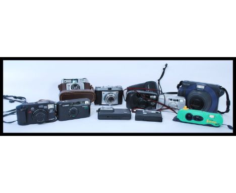 A group of vintage cameras to include Kodak Retinette, disc 6000, Minolta Riva Zoom 135ex, Yashica Zoommate 70, Fujifilm Inst