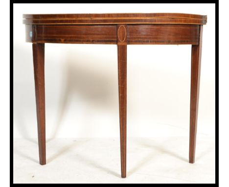 An 18th / 19th century George III mahogany and line inlaid demi lune tea table / games card table. Raised on square tapering 