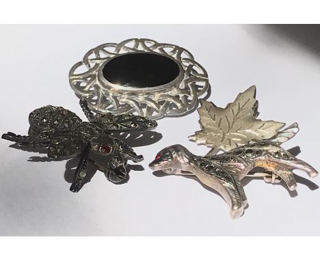 A collection of four vintage brooches to include a silver and marcasite figural brooch in the form of a bumble bee with red s