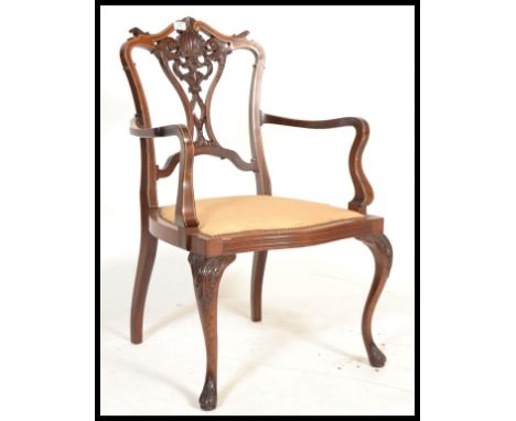 An Edwardian mahogany inlaid salon armchair. Raised on cabriole legs with drop in seat and stunning Chippendale inspired back