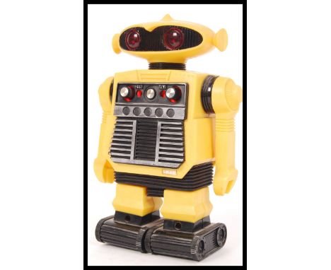 A vintage 1970's Caprice made i-R-1-2 Ms Starroid Robot AM Radio in a yellow and black colourway.&nbsp;