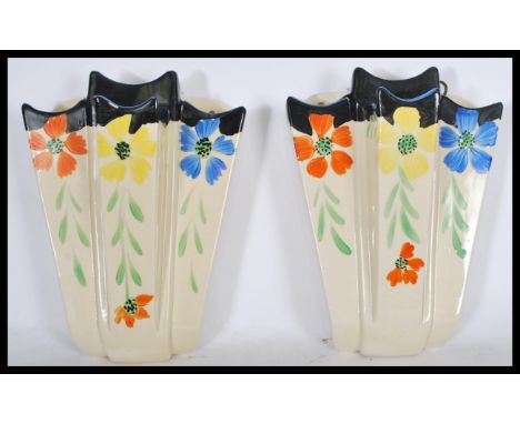 A pair of earl 20th Century Art Deco ceramic hand painted wall pockets, hand painted floral detail, stamped to the verso Arth