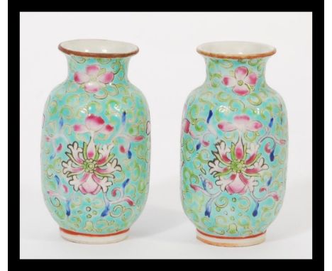 A pair of 19th century Chinese miniature Canton Enamel vases hand decorated with traditional scenes with four ochre red chara