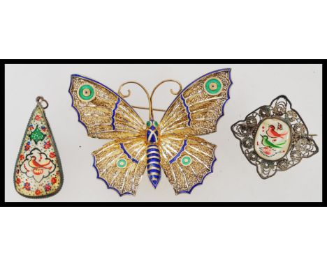 A stunning early 20th century Art Nouveau gilt metal and enamel butterfly brooch with pin verso together with a similar penda