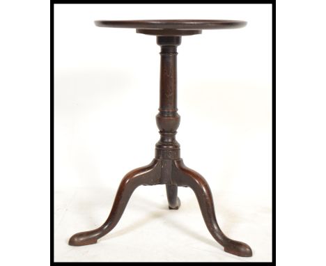 A 19th century George III mahogany tripod wine table. Raised on splayed legs with turned column having circular table top abo