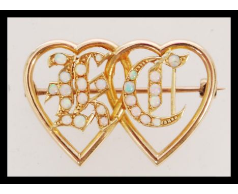 A Victorian 15ct gold and opal set sweetheart Luckenbooth style brooch having entwined hearts with opal set initials, K C,&nb