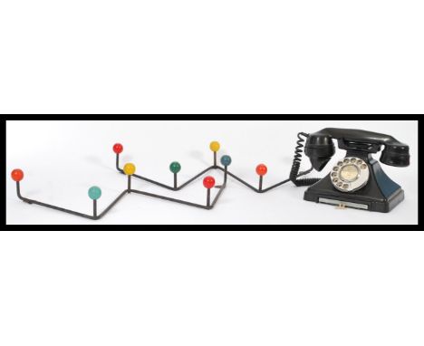 A vintage mid 20th Century bakelite telephone together with a pair of retro atomic wall handing coat hooks.