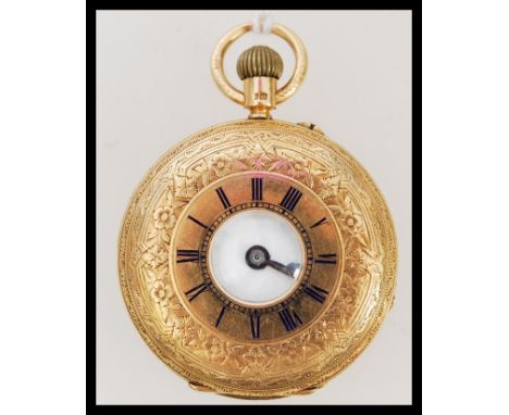 A hallmarked 18ct gold half hunter pocket watch. The white enamel face having a Roman numeral chapter ring and faceted hands.