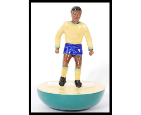 A Royal Doulton Subbuteo ceramic football figurine MCL 12 / 13 featuring a player in Brazilian kit on yellow and green base. 