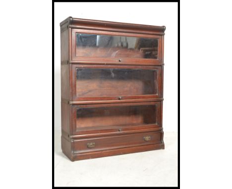 An early 20th Century Globe Wernick mahogany floor standing three sectional glazed lawyers bookcase, each section fitted with