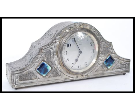 A Tudric pewter Art Nouveau mantle clock in the manner of Archibald Knox of Liberties. The clock having Lapis lazuli / cerami