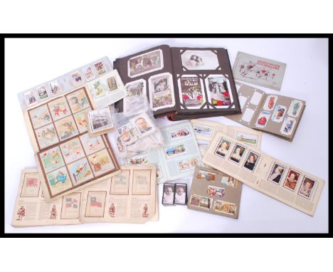 A collection of vintage cigarette cards along with a vintage greeting cards album. Please see images.
