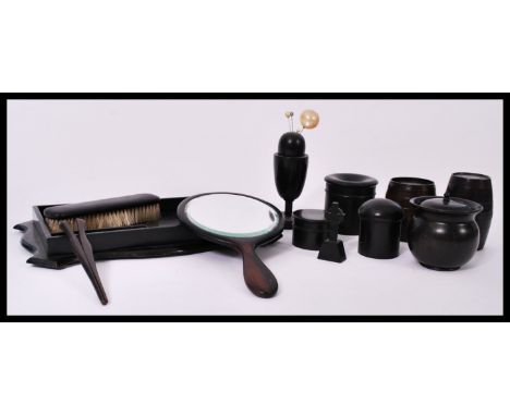 A collection of vintage 20th century ebony beauty dressing table set items to include tray, mirror, pots, stick pins etc.&nbs