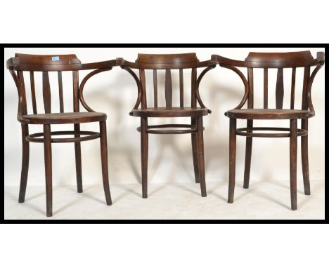 A set of three vintage retro 20th century Thonet type chairs having bowed armrests with circular seats and tapered supports.