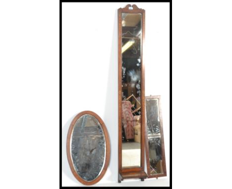 A collection of early 20th century mirrors to include a tall thin hallway mirror with shelf to base together with a small rec