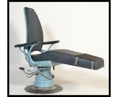 A retro vintage 20th century Dentists  chair in the original blue  colourway. Chrome base with foot pedals. Above shaped supp