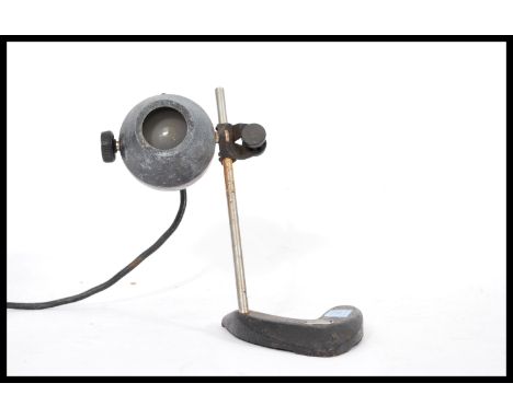 A vintage 20th century Scientific laboratory microscope light lamp raised on a V shapedcast metal base with Eye ball type spu