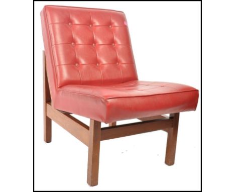 A 1970's retro vintage easy lounge chair / armchair comprising of a button backed crimson red vinyl seat cushion and back cus