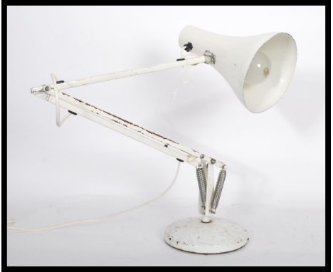 A vintage 20th century industrial anglepoise desk lamp raised on a circular base with pendant shade finished in original whit