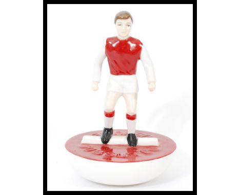 A Royal Doulton Subbuteo ceramic football figurine MCL 12 featuring a player in red and white kit on red and white base. Limi