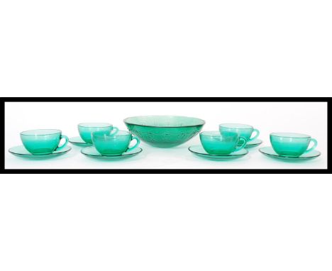 A set of six vintage 20th century French glass cups and saucers by Arcoroc all in green. Makers stamps to insides of cups. Me