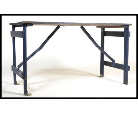 A vintage 20th Century ex=military planked dispersal table, planked top with metamorphic fold out legs with metal securing br