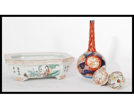 A group of Chinese and Japanese ceramics dating from the 19th century to include an Imari baluster vase decorated in deep cob