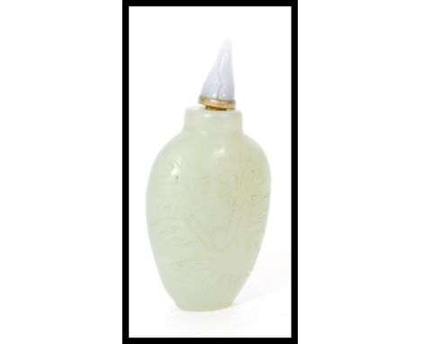 A 19th century Chinese jade scent / perfume bottle of typical form having incised decoration. Measures 7 cm high.