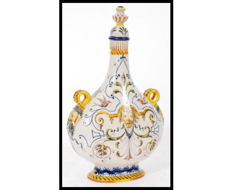 An Italian Majolica Fiance pilgrim moon flask / vase raised on a pedestal base with scrolled grotesque mask hoop handles. Han