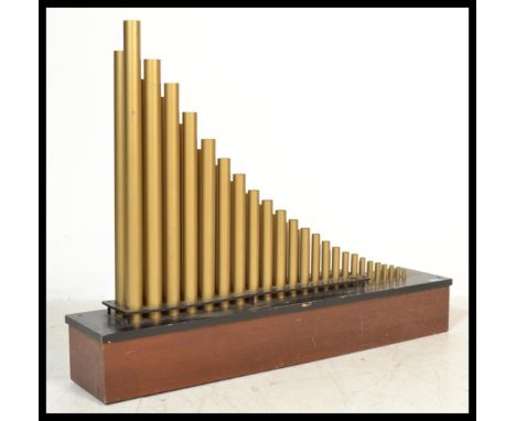 A mounted Organ speaker system by Conn. The mahogany and ebonised base with cylindrical brass tubing of graduating form. Meas