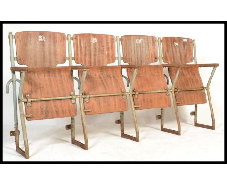 A set of four vintage Industrial mid&nbsp; 20th century cinema - theatre chairs. Set on a metal tubular frame having wooden a