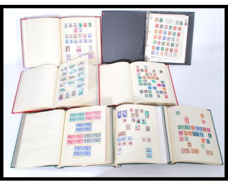 A group of seven vintage stamp albums containing World and GB stamps. Please see images.