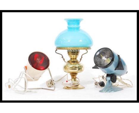 A collection of vintage 20th Century lamps to include an enamel projector, retro heat lamp and a table lamp in the form of an