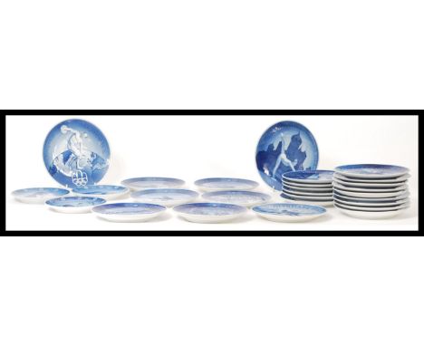 A large collection of Royal Copenhagen ceramic plates top include the complete run of 1967-84 Christmas plates along with add