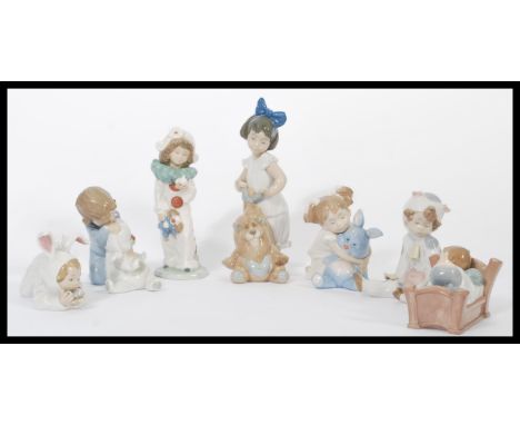 A group of Nao ( Lladro ) ceramic&nbsp; figurines of children to include child sleeping in bed, child with lion, dressed as c