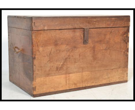 A vintage 19th century hardwood trunk storage blanket box having a hinged lid opening to reveal a spacious interior. Rope han