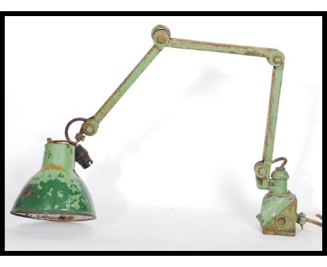 A vintage retro 20th century industrial wall mounted lamp raised on square wall bracket. The three arm light having green con