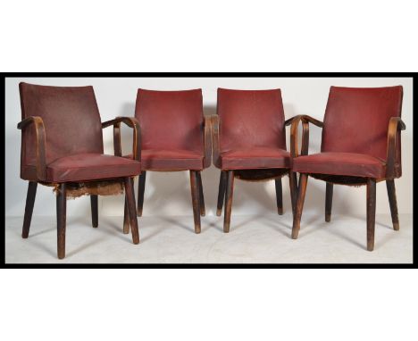 A set of four retro 20th century vintage Ben Chairs bridge type dining chairs&nbsp; being raised on tapered supports with vin