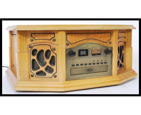 A contemporary antique style hi-fi stereo system in oak wooden effect, The system comprising tape deck, cd player and record 