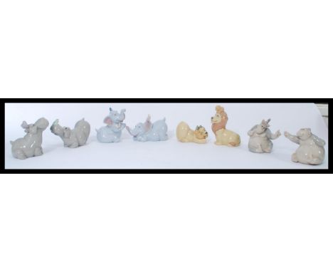 A group of Nao ( Lladro ) figurines of animals to include pair of apes, lions and cubs, elephants and hippos. Please see imag