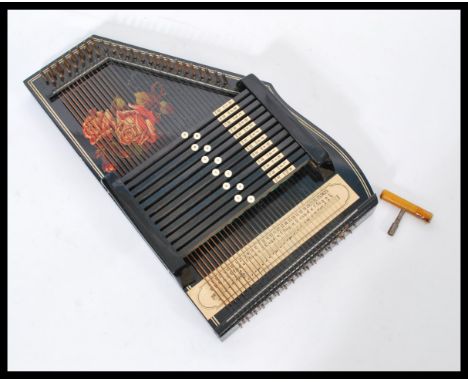 A vintage 20th century Autoharp musical instrument complete in original box with instructions.