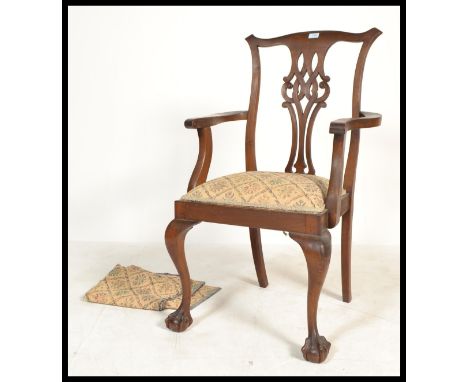 A 19th century carved mahogany Chippendale revival carved carver armchair. The pierced vase back rest over drop in seat with 