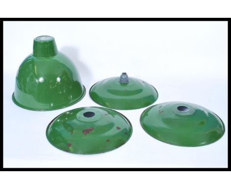 A group of vintage retro 20th century green enamel pendant UFO type shades along with another larger example.