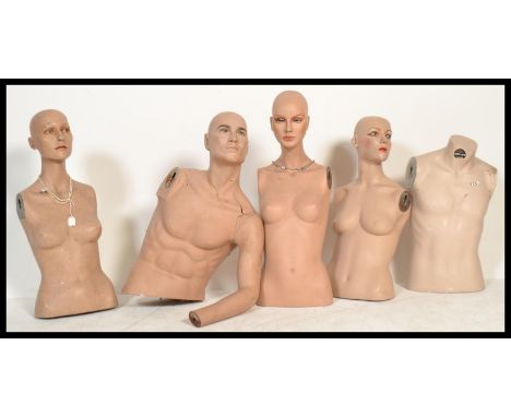 A collection of vintage realistic torso shop mannequins including four female and one male. The mannequins include facial det