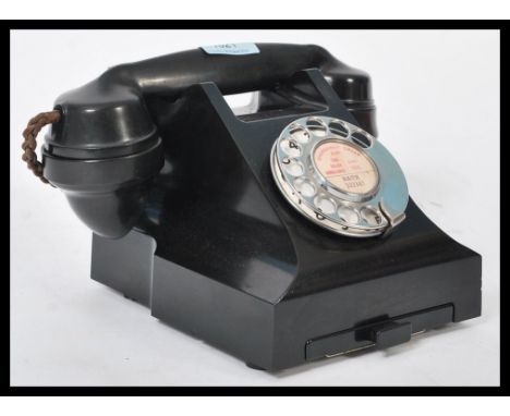 A vintage mid 20th Century bakelite phone with cheese dish and having a recent rewiring to make compatible for modern homes.