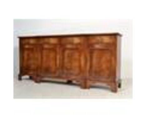 A good flame mahogany large breakfront sideboard being raised on bracket feet with a series of short drawers over cupboards b