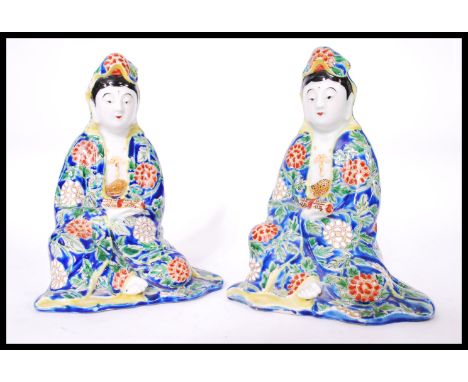 A pair of Chinese Republic period porcelain figures each holding a scroll having hand enamelled cobalt decoration. Measures 1